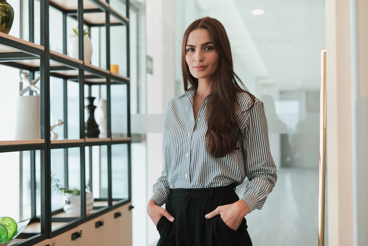 services-01 Portrait of a confident businesswoman standing in a modern office environment.